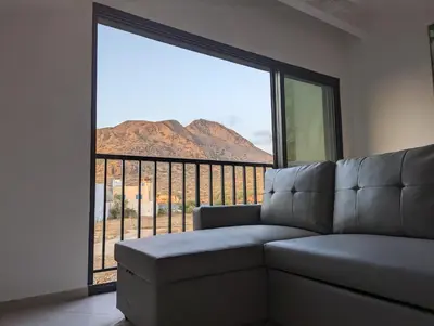 a living room with a couch and a large window at Tarrafal Bay - 1Bdr Apt - Sea view -1 in Tarrafal