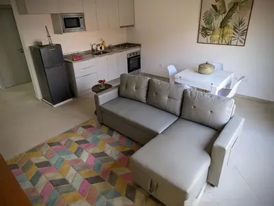 a living room with a couch and a kitchen at Tarrafal Bay - 1Bdr Apt - Sea view -1 in Tarrafal
