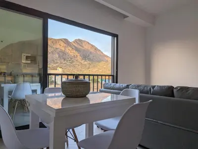 a living room with a couch and a table and chairs at Tarrafal Bay - 1Bdr Apt - Sea view -1 in Tarrafal