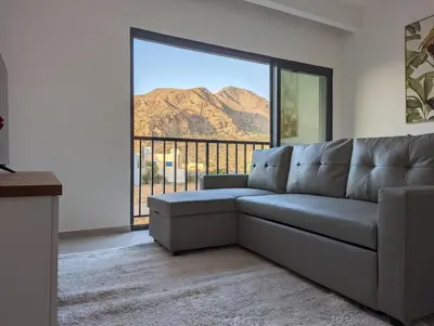 a living room with a couch and a view of a mountain at Tarrafal Bay - 1Bdr Apt - Sea view - 2 in Tarrafal