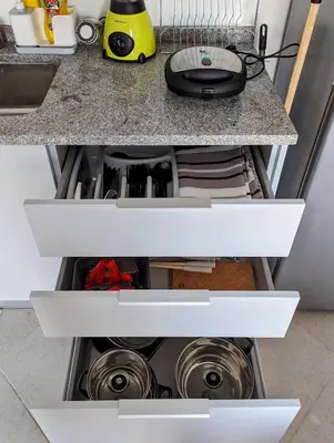 an open kitchen drawer with two pots and pans at Tarrafal Bay - 1Bdr Apt - Sea view - 2 in Tarrafal