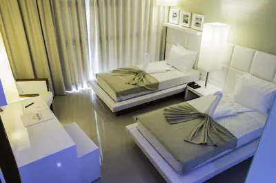 a bedroom with two beds with bows on them at Hotel Vip Praia in Praia
