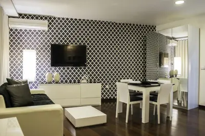 a living room with a table and a dining room at Hotel Vip Praia in Praia