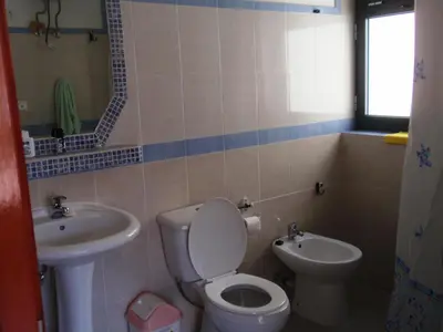 a bathroom with a toilet and a sink at Zena Star in Tarrafal