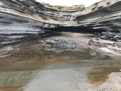 a cave with a pool of water inside of it at Zena Star in Tarrafal