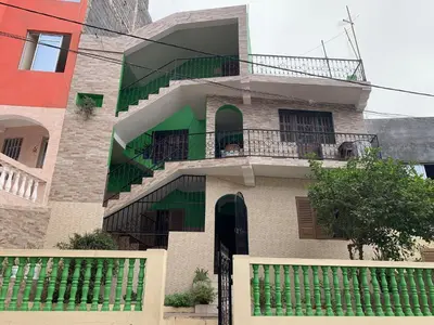 a building with a staircase and a balcony at Ramos Apartamento in São Filipe