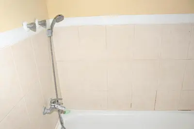 a shower with a shower head in a bathroom at Ramos Apartamento in São Filipe