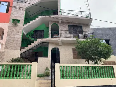a building with a staircase and a balcony at Ramos Apartamento in São Filipe