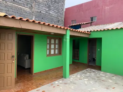 a small green house with a red roof at Ramos Apartamento in São Filipe