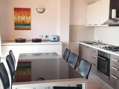 a kitchen with a table and chairs in it at Penthouse with Panoramic Ocean Views and unlimited WiFi in Santa Maria
