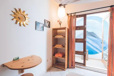 a room with a table and a window at Casa Strela B&B Tarrafal in Tarrafal
