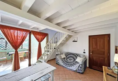 a living room with a staircase and a couch at Beautiful loft in Porto Antigo 1 in Santa Maria