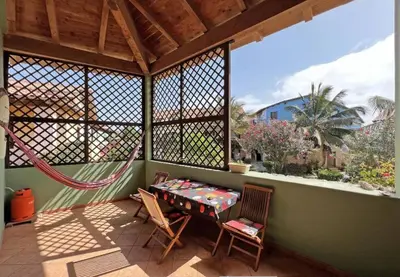 a porch with two chairs and a table on a balcony at Beautiful loft in Porto Antigo 1 in Santa Maria