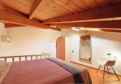 a bedroom with a bed and a wooden ceiling at Beautiful loft in Porto Antigo 1 in Santa Maria