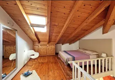 a bedroom with a bed and a wooden ceiling at Beautiful loft in Porto Antigo 1 in Santa Maria