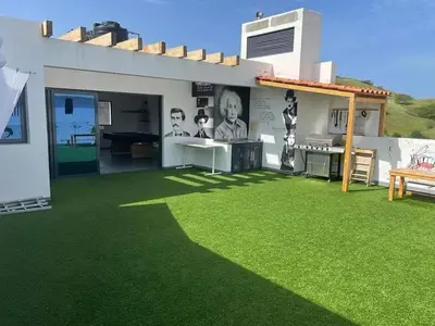 a house with a yard with green grass at Apto T0 na Capital in Praia