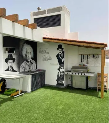 a house with a kitchen with green grass at Apto T0 na Capital in Praia