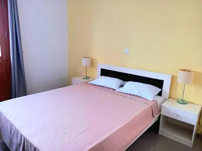 a bedroom with a large white bed with two night stands at Apartamento em Santa Maria- Espaçoso&Confortável in Santa Maria