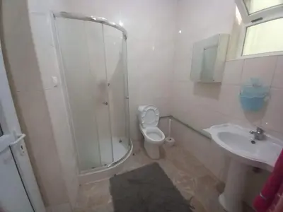 a bathroom with a shower and a toilet and a sink at Casa Herminia in Tarrafal