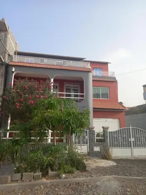 a house with a tree in front of it at Casa Herminia in Tarrafal