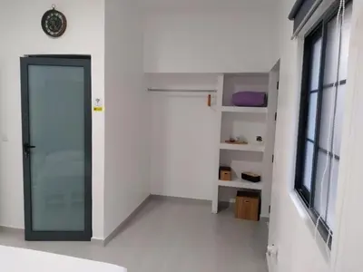 a white room with a door and a window at Palmira House in Cidade Velha