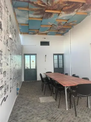 a conference room with a wooden table and chairs at Palmira House in Cidade Velha