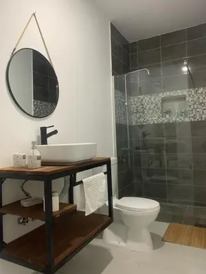 a bathroom with a toilet and a sink and a mirror at Palmira House in Cidade Velha