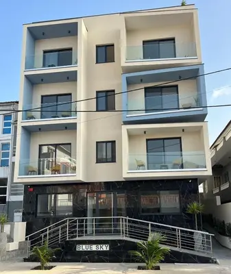 an apartment building with a blue sky in the background at Hôtel Blue Sky in Tarrafal