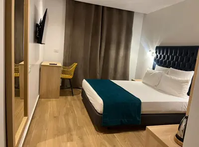 a hotel room with a bed and a window at Hôtel Blue Sky in Tarrafal