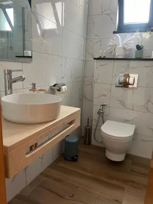 a bathroom with a sink and a toilet at Hôtel Blue Sky in Tarrafal