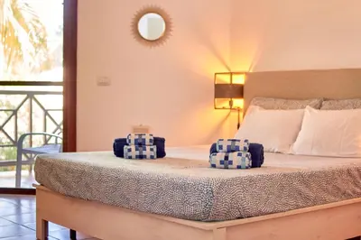 a bedroom with a bed with two pillows on it at Calma de Sal Porto Antigo II Beach apartment in Santa Maria