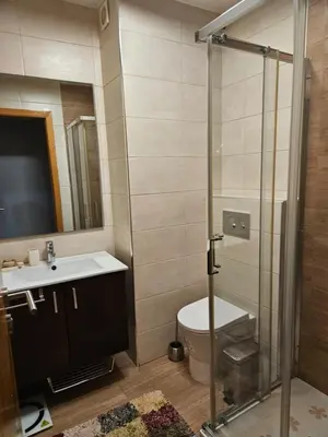 a bathroom with a shower and a toilet and a sink at Apart Nel in Praia