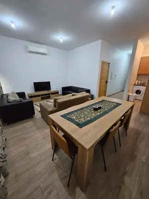 a living room with a table and a couch at Apart Nel in Praia