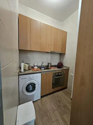 a kitchen with a washing machine and a washer at Apart Nel in Praia