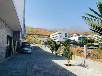 a street with a car parked on the side of a building at COSEC Tours in Cova Figueira
