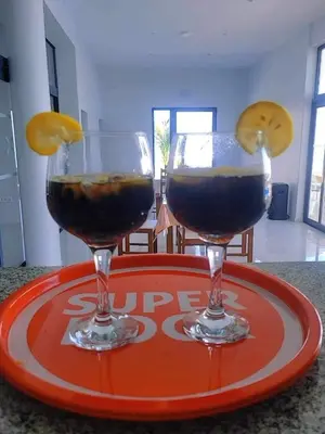 two wine glasses sitting on a red plate at COSEC Tours in Cova Figueira