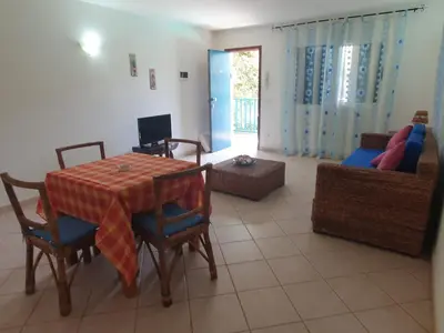 a living room with a table and chairs and a couch at Holiday Properties Leme Bedje in Santa Maria
