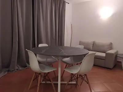 a table and chairs in a living room with a couch at Apartament in Porto Antigo 2 - Santa Maria in Santa Maria