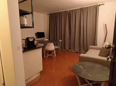 a kitchen and a living room with a table and a couch at Apartament in Porto Antigo 2 - Santa Maria in Santa Maria