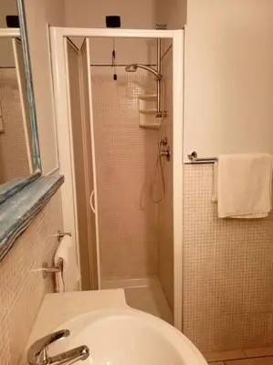 a bathroom with a shower with a sink and a toilet at Apartamento Djadsal Moradias L01 próximo à praia in Santa Maria