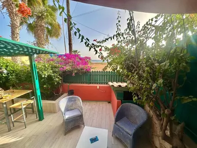 a patio with a table and chairs and flowers at Boutique Apartments Ibiscus in Santa Maria