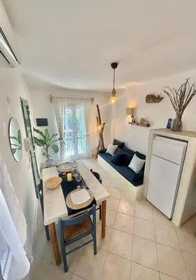 a living room with a table and a couch at Boutique Apartments Ibiscus in Santa Maria