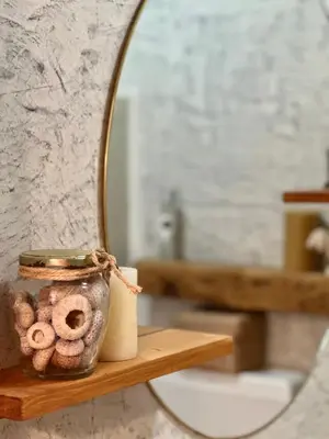 a bathroom with a mirror and a jar of donuts at Boutique Apartments Ibiscus in Santa Maria
