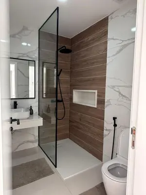 a bathroom with a shower and a toilet and a sink at Sharksproperties Apartment in Mindelo