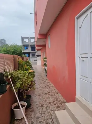 a corridor of a building with potted plants on it at Jbct & SOLANGE APART in Praia