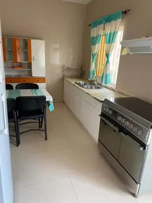 a kitchen with a sink and a stove top oven at Jbct & SOLANGE APART in Praia