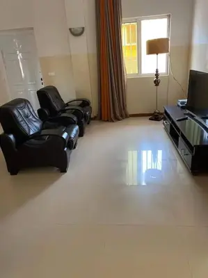 a living room with two chairs and a television at Jbct & SOLANGE APART in Praia