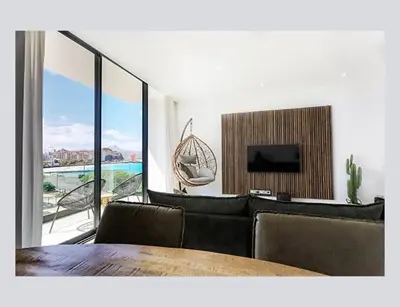 a living room with a couch and a flat screen tv at Filomena Apartments ORIENTAL in Mindelo
