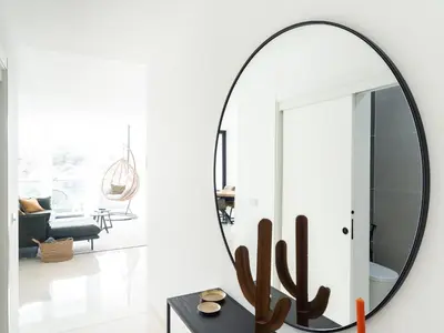 a large round mirror in a living room at Filomena Apartments ORIENTAL in Mindelo