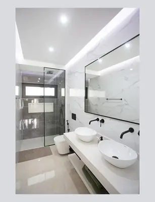 a white bathroom with two sinks and a shower at Filomena Apartments ORIENTAL in Mindelo